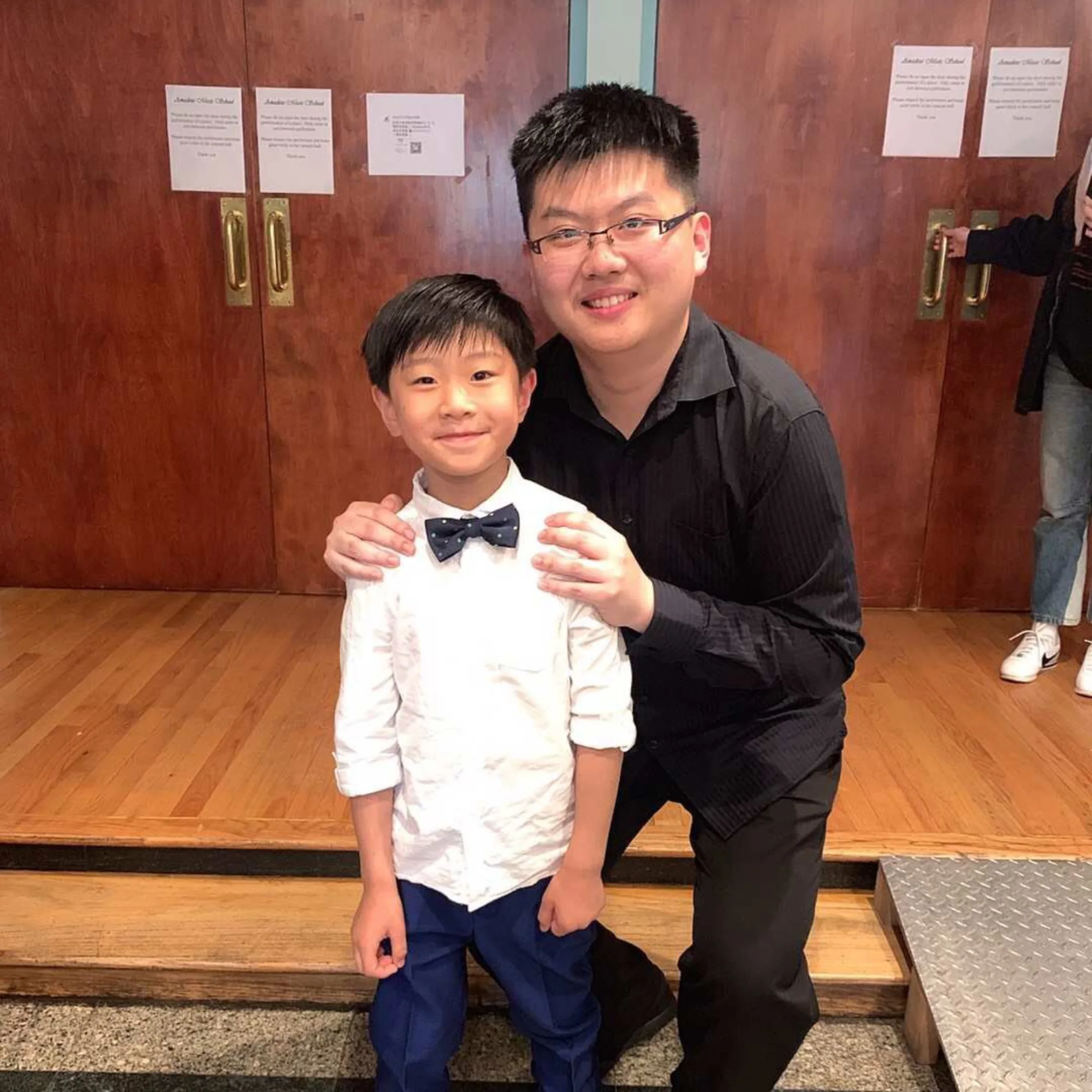 Xingyu Liu teaching a young piano student at the keyboard